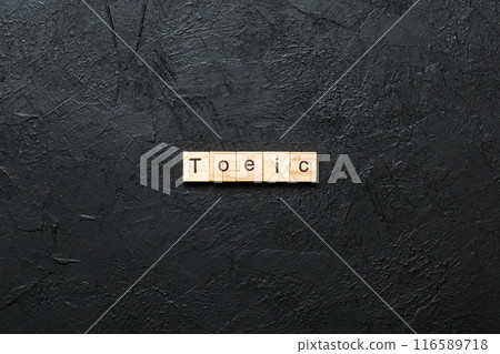 toeic word written on wood block. toeic text on table, concept toeic word written on wood block. toeic text on table, concept 116589718