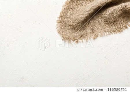 Old burlap fabric napkin, sackcloth on table background. top view with copy space Old burlap fabric napkin, sackcloth on table background. top view with copy space 116589731