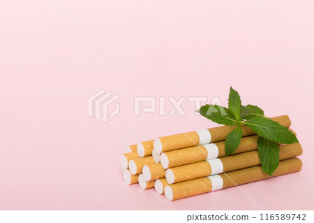 Menthol cigarettes and fresh mint leaves on colored background, Many cigarettes stacked together top view flat lay 116589742