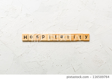 hospitality word written on wood block. hospitality text on table, concept 116589764