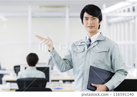 Engineers in work clothes working in an office 116591140