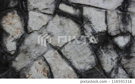 Smooth edges of stones in ancient wall texture background  116591316
