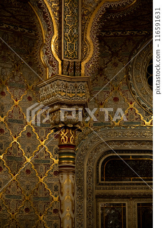 The building is ornate with columns, windows, wood art, and symmetry 116591631