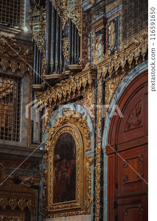 The church features a door and a painting hanging on the wall The church features a door and a painting hanging on the wall 116591650
