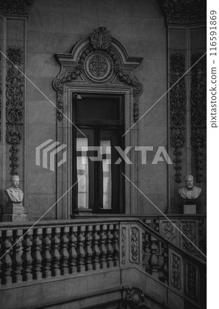 Black and white photo of a building with stairs and window, showing symmetry 116591869
