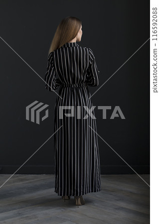 young beautiful woman on a dark background, full length studio shot 116592088