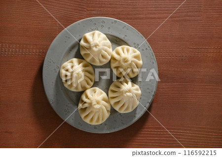 Overhead view of a plate with traditional Georgian dish khinkali Overhead view of a plate with traditional Georgian dish khinkali 116592215