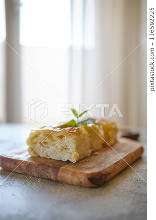 Georgian cheese pie Achma cut on pieces on a table 116592225