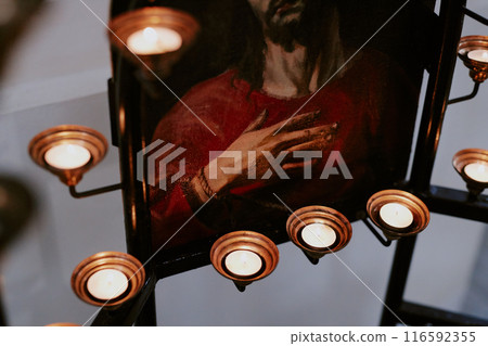 Medium closeup of part of icon and candles at altar in Catholic church Medium closeup of part of icon and candles at altar in Catholic church 116592355