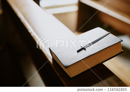 High angle view closeup of prayer book on wooden bench in Catholic church, copy space 116592805