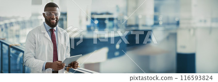 Happy young black man in workwear and protective glasses medical scientist with using digital tablet, analyzing data, posing at workplace, panorama with copy space. Jobs and occupations concept 116593824