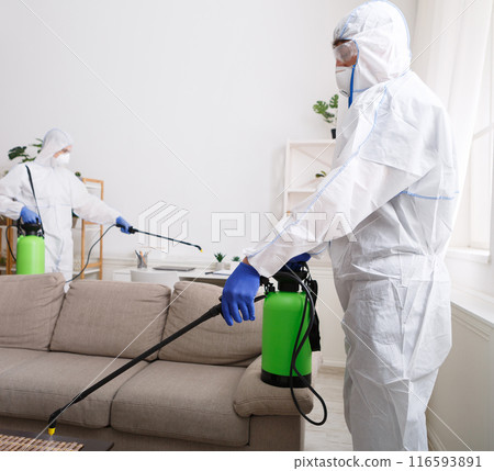 Coronavirus disinfection. People in hazmats making disinfection in flat, copy space, hot steam disinfection 116593891