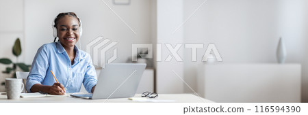 Young Smiling Black Lady Student Studying Online With Laptop, Listening Music And Taking Notes, Sitting At Desk At Home, Enjoying Distance Learning, Preparing For Exams With Computer, Copy Space Young Smiling Black Lady Student Studying Online With Laptop, Listening Music And Taking Notes, Sitting At Desk At Home, Enjoying Distance Learning, Preparing For Exams With Computer, Copy Space 116594390