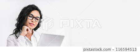 Office Person. Beautiful hispanic businesswoman using digital tablet working at modern office, vertical image, panorama with copy space Office Person. Beautiful hispanic businesswoman using digital tablet working at modern office, vertical image, panorama with copy space 116594513