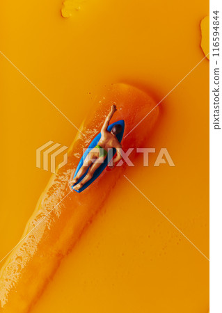 miniature surfer man on an orange freeze pop 116594844