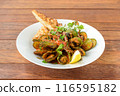 Mussels with Sauce and Bread is a classic dish that epitomizes coastal dining.  116595182