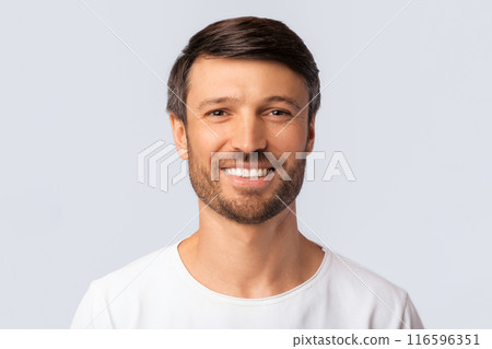 Portrait Of Cheerful Man Smiling At Camera Over White Background In Studio. Isolated 116596351