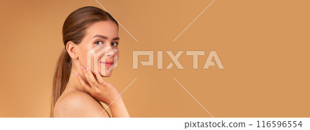 Beauty and fashion. Sexy young lady with silky hair and soft skin touching her face on beige background, copy space Beauty and fashion. Sexy young lady with silky hair and soft skin touching her face on beige background, copy space 116596554