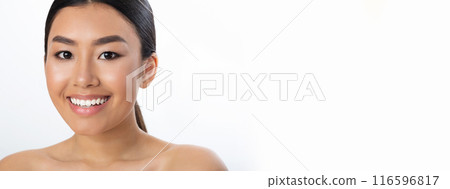 Half-naked young pretty asian woman posing over white studio background, smiling at camera, panorama with copy space Half-naked young pretty asian woman posing over white studio background, smiling at camera, panorama with copy space 116596817