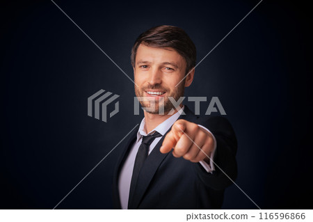 You're Next. Confident Businessman Pointing Finger Smiling At Camera Over Black Background. Studio Shot, Free Space You're Next. Confident Businessman Pointing Finger Smiling At Camera Over Black Background. Studio Shot, Free Space 116596866