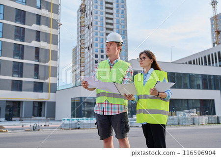 Two industrial construction workers discussing project plan for engineering work Two industrial construction workers discussing project plan for engineering work 116596904