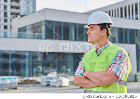 Young confident male engineer, builder, industrial worker at construction site 116596920