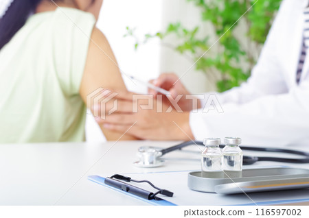 Male doctor and female patient giving an injection to the arm 116597002