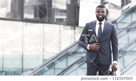 Successful African Businessman Going On Business Meeting Holding Briefcase Walking In Urban Area In City. Vertical, Full Length 116597005