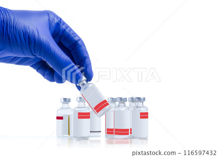 Hand in blue glove holding vaccine vials isolated on white background. Closeup 116597432