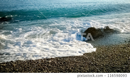 Foamy waves of a sea blue water rocks of the shore in Antibes, France 116598093