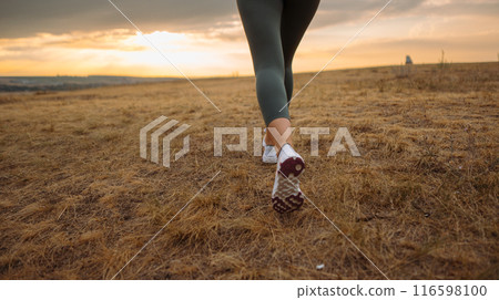 In autumn, a woman shows adventurous spirit by hiking, promoting an active and healthy lifestyle 116598100