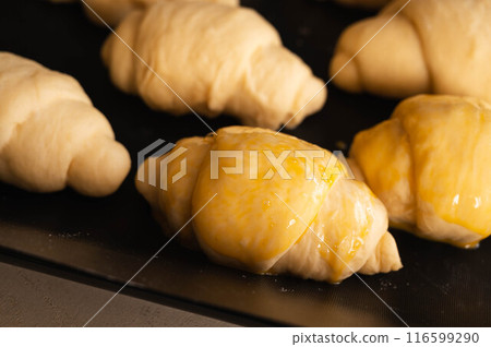 Bread making: Brushing the surface with egg 116599290