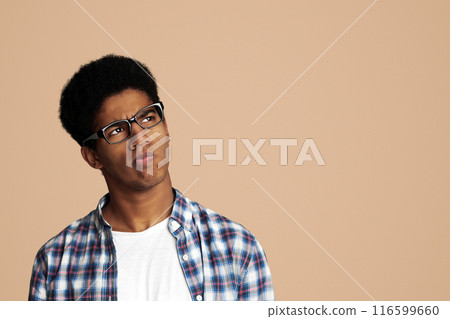 Thoughtful Afro Guy Thinking and Looking Aside over White Background Thoughtful Afro Guy Thinking and Looking Aside over White Background 116599660