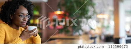 Dreamy young black lady in glasses enjoying cup of coffee in cafe, thinking about future opportunities, close up, copy space 116599673