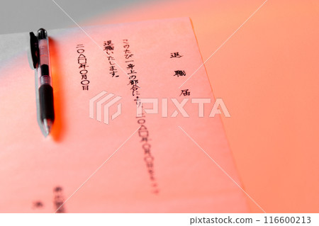 A scene of a handwritten resignation letter and a black gel ink pen placed on a white table, shot with a slightly reddish light. A scene of a handwritten resignation letter and a black gel ink pen placed on a white table, shot with a slightly reddish light. 116600213