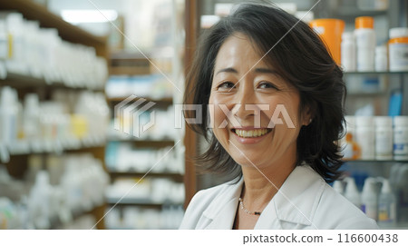 A veteran female pharmacist working at a pharmacy 116600438
