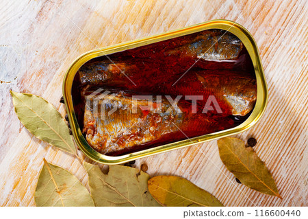 Canned sea fish, mackerel fillets in tomato served with peppers and bay leaf Canned sea fish, mackerel fillets in tomato served with peppers and bay leaf 116600440