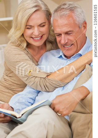 Healthy Senior Man Woman Couple at Home Smiling Reading a Book 116601585