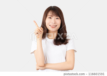 A smiling Japanese woman pointing with her index finger up A smiling Japanese woman pointing with her index finger up 116601591