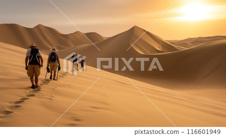 Tourists Trekking Through a Vast Desert at Sunrise 116601949