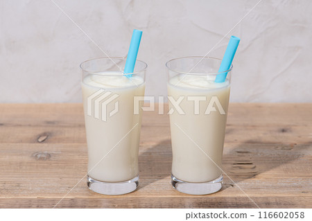 Vanilla shake with straw on table Vanilla shake with straw on table 116602058