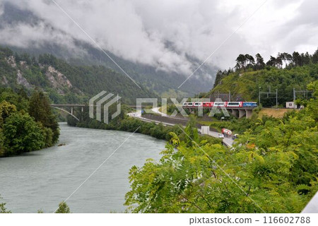 The Glacier Express came running in the rain. It's bound for Zermatt. The Glacier Express came running in the rain. It's bound for Zermatt. 116602788