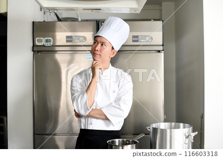 Young chef asian man thinking in the kitchen 116603318