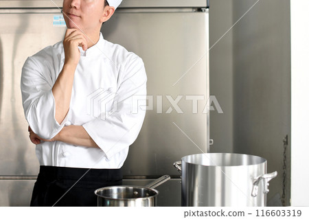 Young chef asian man thinking in the kitchen 116603319