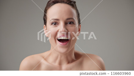 Beauty, health, cosmetics, anti-aging therapy and skin care concept - young beautiful brunette Caucasian woman opens her eyes wide in surprise and surprise 116603960