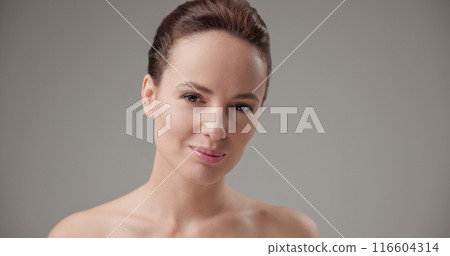 Beauty, health, cosmetics, anti-aging therapy and skin care concept - young beautiful brunette Caucasian woman posing in front of the camera, opening and closing her eyes 116604314