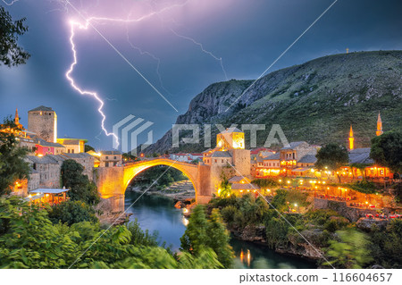 Majestic evening view of Mostar with the Mostar Bridge, houses and minarets, at evening. Majestic evening view of Mostar with the Mostar Bridge, houses and minarets, at evening. 116604657