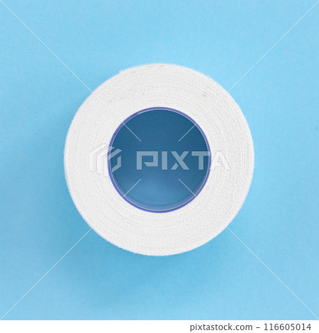 white roll band aid strip isolated on blue white roll band aid strip isolated on blue 116605014
