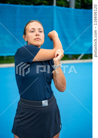 Professional female tennis player warming up before tennis play on outside court Professional female tennis player warming up before tennis play on outside court 116606120
