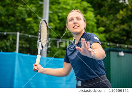 Professional female tennis player playing in tennis with racket and ball on outside court Professional female tennis player playing in tennis with racket and ball on outside court 116606121